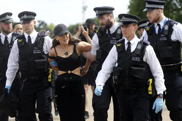 A woman is arrested during a mass gathering protest organised by the group called 'UK Freedom Movement', in Hyde Park in London as the country is in lockdown to help stop the spread of coronavirus, Saturday, May 16, 2020. The group claims that the coronavirus lockdown is illegal. (Photo by Kirsty Wigglesworth/AP Photo)