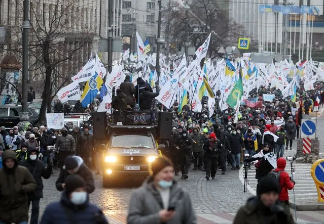 Protesters march along the Streets during the demonstration in Kiev, Ukraine, on December 22, 2020. Hundreds of protesters gathered to protest against the introduction of restrictive measures due to the COVID-19 coronavirus epidemic. (Photo by Pavlo Gonchar/SOPA Images/LightRocket via Getty Images)