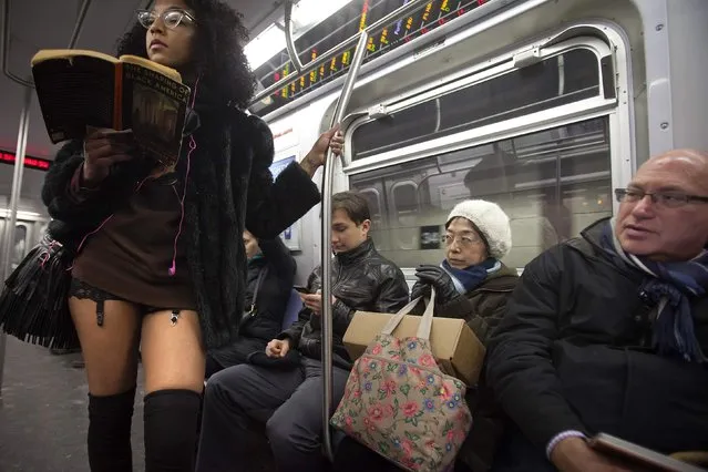 Passengers sit near a participant in the “No Pants Subway Ride” in the Q subway from Times Square in the Manhattan borough of New York January 11, 2015. (Photo by Carlo Allegri/Reuters)