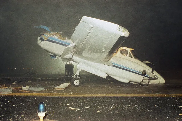 Emergency workers study the wreckage of a Beechcraft King Air twin-engine plane after it was hit by an Eastern Airlines 727 at Hartsfield Atlanta International Airport in Georgia, January 19, 1990. One person was killed in the crash. (Photo by AP Photo)