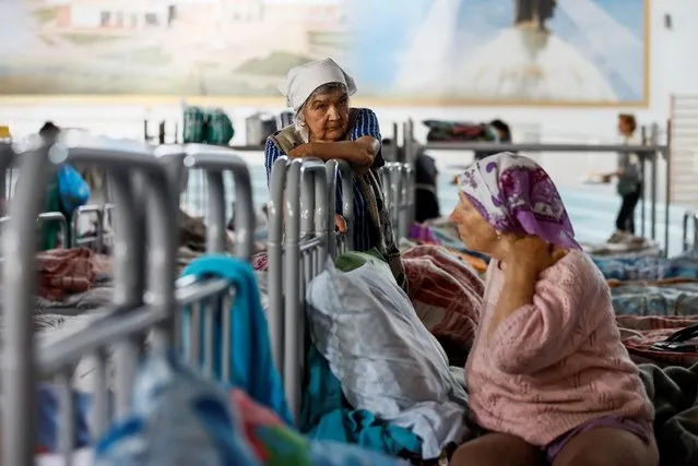 Residents of the Shebekinsky district of Russia's Belgorod region, who were evacuated following recent attacks on settlements near the Russia-Ukraine border in the course of a military conflict, stay at a temporary accommodation centre located in a sports facility in the city of Belgorod, Russia on June 7, 2023. (Photo by Maxim Shemetov/Reuters)