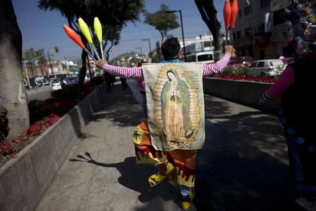 A clown wears an image of the Virgin of Guadalupe as he walks in procession toward the Basilica of Our Lady of Guadalupe in Mexico City, Monday, December 14, 2015. (Photo by Rebecca Blackwell/AP Photo)