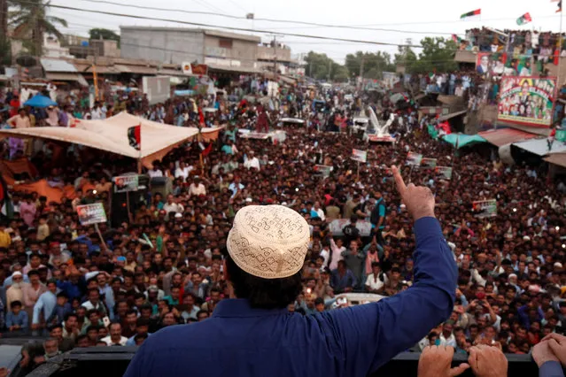 Bilawal Bhutto Zardari, chairman of the Pakistan People's Party (PPP), wearing a Sindhi topi hat, gestures as he speaks to supporters from the roof of his bullet-proof bus, during a campaign rally ahead of general elections in District Thatta, Pakistan July 2, 2018. (Photo by Akhtar Soomro/Reuters)
