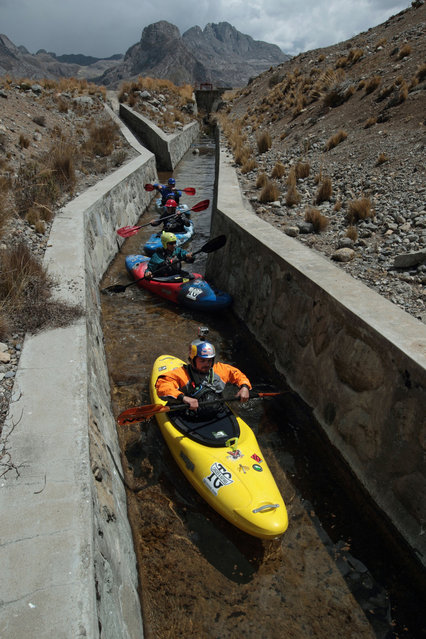 August 18, 2012 – Alpamarca, Peru – Amazon Express team members from bottom, Rafael Ortiz, of Mexico, Jeff Wueste, of Austin, Texas, John Maika, of Austin, Texas,and expedition leader West Hansen, of Austin, Texas, come out of Laguna Acucocha into the outflow canal that begins the Rio Gashan. (Photo by Erich Schlegel/zReportage via ZUMA Press)