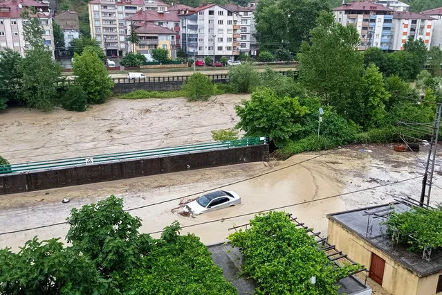 A partially submerged car is visible in floodwaters after heavy rains in Zonguldak, Turkey, Monday, July 10, 2023. Scientists have long warned that more extreme rainfall is expected in a warming world. (Photo by Dia Images via AP Photo)