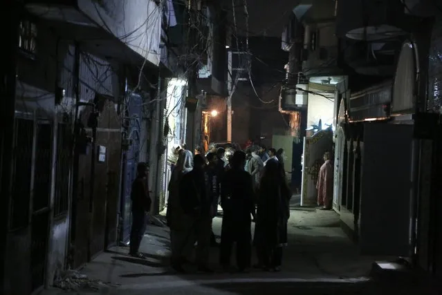 People stand outside their homes after an earthquake in Rawalpindi of Pakistan's Punjab province on February 12, 2021. A strong earthquake hit Pakistan and the tremor was felt in Islamabad late Friday. Local media said the magnitude was registered at 6.4. (Photo by Chine Nouvelle/SIPA Press/Rex Features/Shutterstock)
