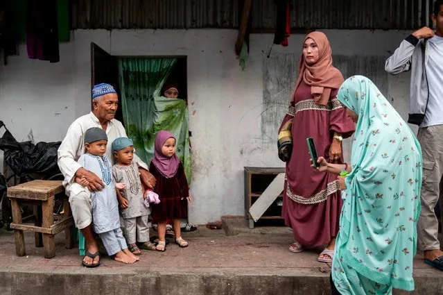 Members of a Filipino muslim family have their photo taken before going to a mosque for Eid al-Adha prayers in Marikina City, Metro Manila, Philippines on June 28, 2023. (Photo by Lisa Marie David/Reuters)