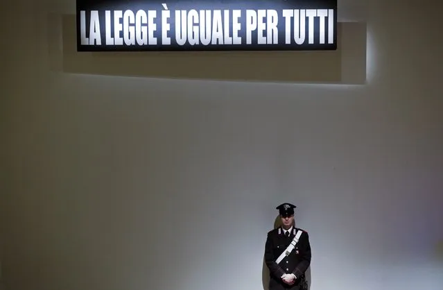 A Carabiniere paramilitary policeman stands below a sign that reads, “The law is equal for everyone”, during the trial of the captain of the Costa Concordia cruise liner Francesco Schettino in Grosseto February 9, 2015. (Photo by Max Rossi/Reuters)