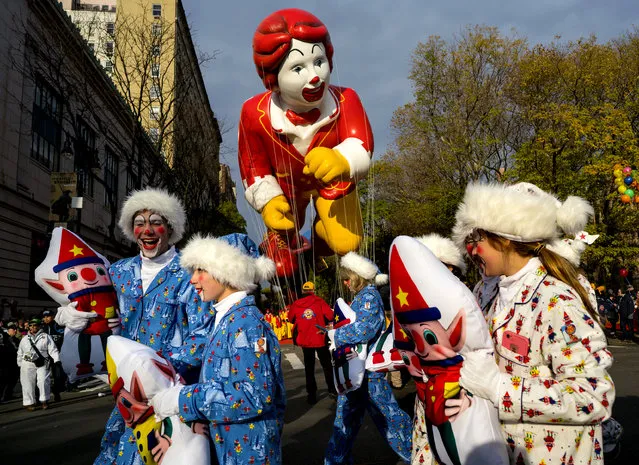 Participants walk along Central Park West at the start of the Macy's Thanksgiving Day Parade in New York Thursday, November 24, 2016. (Photo by Craig Ruttle/AP Photo)