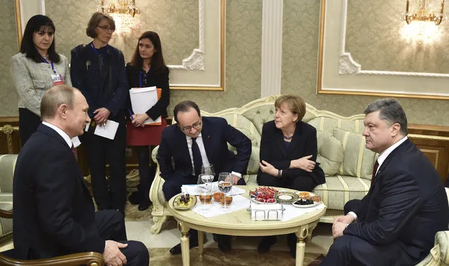 Left to right, Russian President Vladimir Putin,  French President Francois Hollande, German Chancellor Angela Merkel, and Ukrainian President Petro Poroshenko talk in Minsk, Belarus, Wednesday, February 11, 2015. (Photo by Mykola Lazarenko/AP Photo)