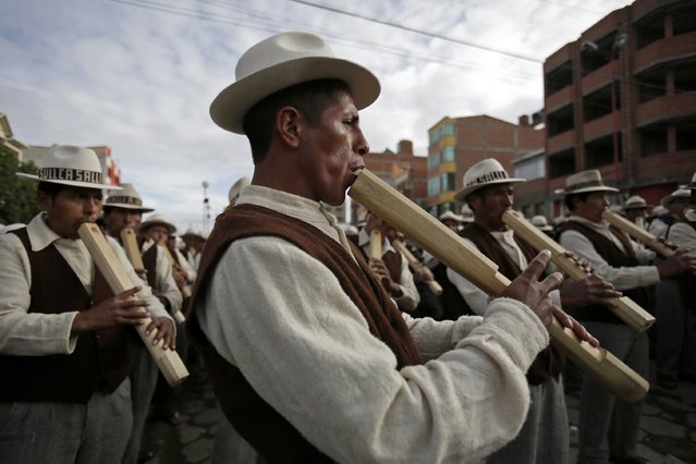 Indigenous musicians from Curahuara de Carangas play their “Tarkas”, a native instrument, during the Anata Andina (Andean carnival) parade in Oruro, February 12, 2015. (Photo by David Mercado/Reuters)