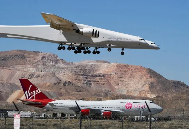 The Stratolaunch plane, the world's largest, comes in for a landing over Virgin Orbit 747 Cosmic Girl after it performed a 2nd test flight in Mojave, California, U.S., April 29, 2021. The plane, designed to transport hypersonic vehicles and facilitate easy access to space, made its second test flight, two years after its first voyage. (Photo by Gene Blevins/Reuters)