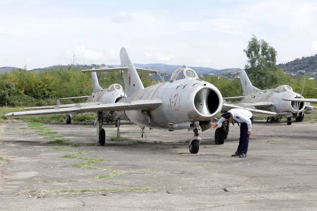 An Albanian Air Force crew member inspects a MiG-17 jet fighter in Kucova Air Base in Kucova, Albania on October 3, 2018. "The base is the first footprint of NATO in the Western Balkans as it will transform Kucova into the first NATO air base for the region," Defence Minister Olta Xhacka told Reuters. NATO will spend over 50 million euros ($58 million) on the first stage of work to turn Kucova into a support base for supplies, logistics, training and drills, Xhacka said. (Photo by Florion Goga/Reuters)