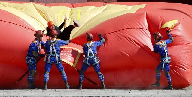 Rescuers from Kyrgyzstan's Ministry of Emergency Situations operating a fire rescue air cushion as they take part in anti-terrorism exercises at CHPP-2 near Bishkek, Kyrgyzstan on September 21, 2023. The “Eurasia-Antiterror – 2023”, the first joint anti-terrorist exercises of the Commonwealth of Independent States (CIS) and the Shanghai Cooperation Organization (SCO) took place in the Kyrgyz Republic. Eleven CIS and SCO member states (Armenia, Belarus, India, Iran, Kazakhstan, China, Kyrgyzstan, Pakistan, Russia, Tajikistan and Uzbekistan) took part in the joint anti-terrorist exercises. (Photo by Igor Kovalenko/EPA/EFE)