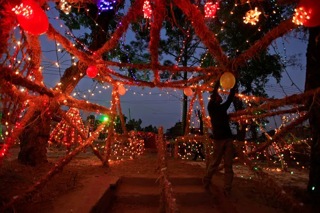 A man decorates a Christian neighborhood on the eve of Christmas celebrations in Islamabad, Pakistan, December 24, 2016. (Photo by Faisal Mahmood/Reuters)