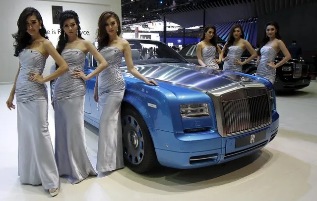 Models pose beside a Rolls-Royce Phantom Drophead Coupe Waterspeed during a media presentation of the 36th Bangkok International Motor Show in Bangkok March 24, 2015. The Bangkok International Motor Show will be held from March 25 to April 5. (Photo by Chaiwat Subprasom/Reuters)