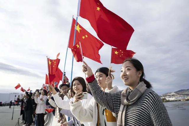 In this photo released by Xinhua News Agency, people wave Chinese flags to welcome Chinese President Xi Jinping in San Francisco, Tuesday, November 14, 2023. Ahead of the highly anticipated meeting on Wednesday between U.S. President Joe Biden and Chinese leader Xi Jinping, Chinese state media have taken a new tone toward the U.S. with less negative coverage, calls for a return to warmer ties and stories of Americans with positive connections to the country. (Photo by Liu Jie/Xinhua via AP Photo)