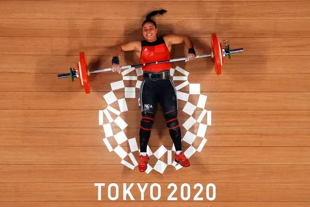 This picture taken with a robotic camera shows Nicaragua's Sema Nancy Ludrick Rivas competing in the women's 64kg weightlifting competition during the Tokyo 2020 Olympic Games at the Tokyo International Forum in Tokyo on July 27, 2021. (Photo by Chris Graythen/Reuters)