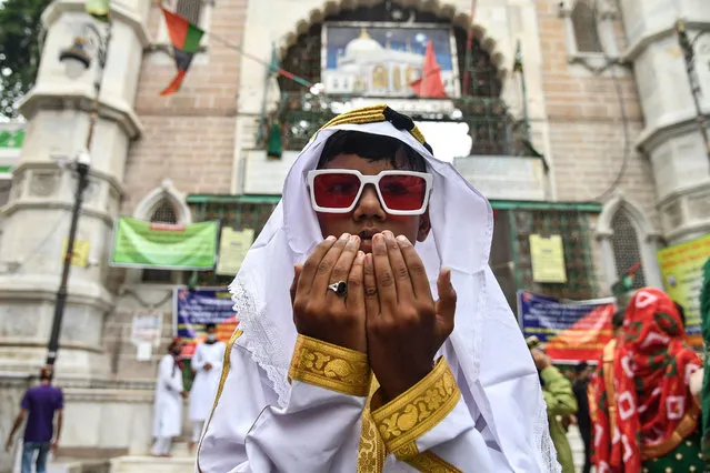 A young Muslim devotee offers prayers during the Eid al-Adha or the “Festival of Sacrifice”, in Ajmer on July 21, 2021. (Photo by Shaukat Ahmed/AFP Photo)