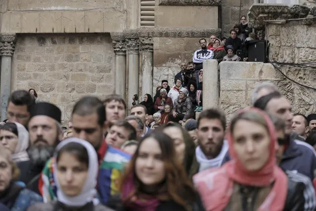 People participate in the washing of the feet ceremony outside the Church of the Holy Sepulchre in Jerusalem's Old City, April 9, 2015, ahead of Orthodox Easter. (Photo by Ammar Awad/Reuters)