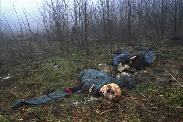 In this February 4, 1996, file photo one of four clothed skeletons being examined by U.N. investigator Elizabeth Rehn as she tries identify an estimated 8,000 Muslim men missing after the Serb conquest of the former Muslim enclave of Srebrenica in July 1995, lies on a hilltop. Twenty-six years after the July 1995 Srebrenica massacre, the only episode of Bosnia’s 1992-95 war to be legally defined as genocide, its survivors continue to grapple with the horrors they endured while also confronting increasingly aggressive downplaying and even denial of their ordeal. (Photo by Alexander Zemlianichenko/AP Photo/File)