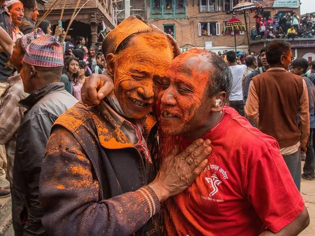 Two devotees with their faces covered in vermillion powder celebrate the new year during the Sindoor Jatra Festival on April 15, 2015 in Thimi, Nepal. (Photo by Omar Havana/Getty Images)