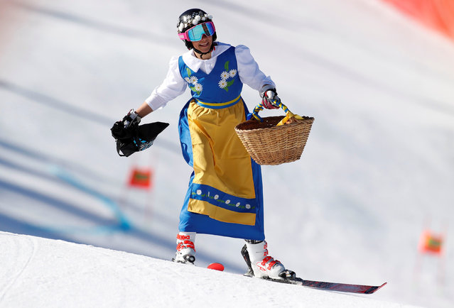 Sweden's Frida Hansdotter dressed-up with a Swedish traditional dress and holding a basket full of cakes competes in her last race, the first round of the Women's giant slalom race during the FIS Alpine ski world cup championship on March 17, 2019, in Grandvalira Soldeu – El Tarter, in Andorra. (Photo by Christian Hartmann/Reuters)