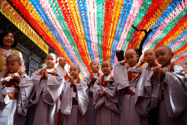 Novice monks leave after an event to celebrate the upcoming Vesak Day, birthday of Buddha, at Jogye temple in Seoul, South Korea, April 22, 2019. (Photo by Kim Hong-Ji/Reuters)
