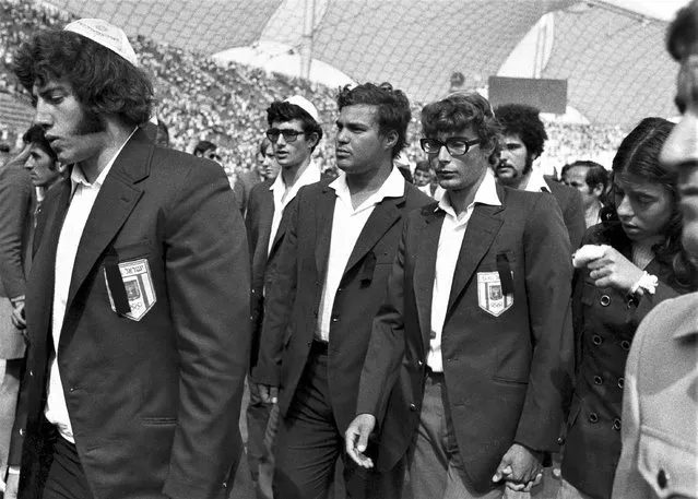 Members of Israel's Olympic team place black ribbons in their pockets after a memorial service mourning their comrades killed in Tuesday's Arab terrorists attack and subsequent police shoot-out leave the Olympic stadium in Munich, then West Germany, Wednesday, September 6, 1972. The German government said Friday, April 21, 2023 it has set up an international commission of experts to review the events surrounding the 1972 attack on the Munich Olympics, a panel that was part of an agreement reached last year with relatives of the 11 Israeli athletes who were killed by Palestinian militants. (Photo by AP Photo, File)