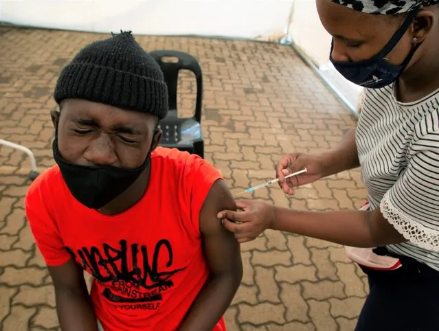 A man receives a dose of a vaccine at a COVID-19 vaccine centre, in Soweto, Monday, November 29, 2021. The World Health Organization has urged countries not to impose flight bans on southern African nations due to concerns over the new omicron variant. (Photo by Denis Farrell/AP Photo)