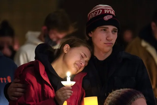 People attending a vigil embrace at LakePoint Community Church in Oxford, Mich., Tuesday, November 30, 2021. Authorities say a 15-year-old sophomore opened fire at Oxford High School, killing several students and wounding multiple other people, including a teacher. (Photo by Paul Sancya/AP Photo)