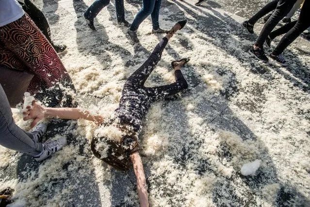 People participate in a pillow fight to mark International Pillow Fight Day in the Heroes' Square, in central Budapest, Hungary, Saturday, April  2, 2016. (Photo by Zoltan Balogh/MTI via AP Photo)