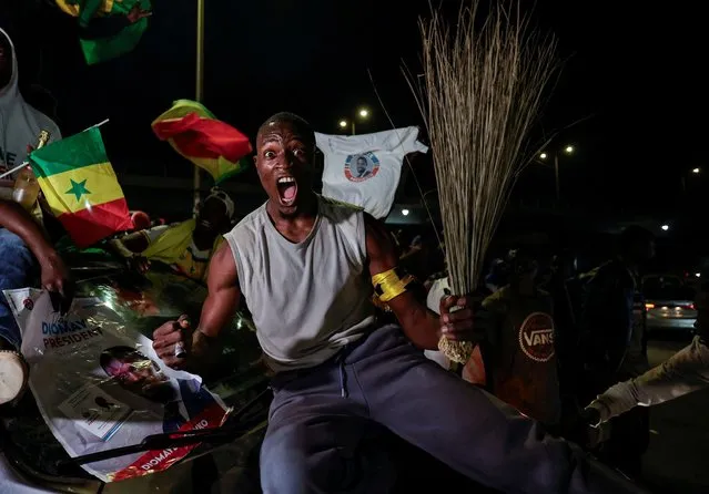 A Supporter of Senegalese presidential candidate Bassirou Diomaye Faye celebrates early results showing that Faye is leading initial presidential election tallies, in Dakar, Senegal on March 24, 2024. (Photo by Zohra Bensemra/Reuters)