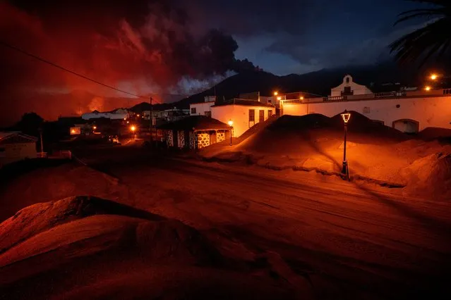 Ash covers the streets and houses in Las Manchas village as lava flows from the volcano, on the Canary island of La Palma, Spain, Monday, December 6 2021. (Photo by Emilio Morenatti/AP Photo)