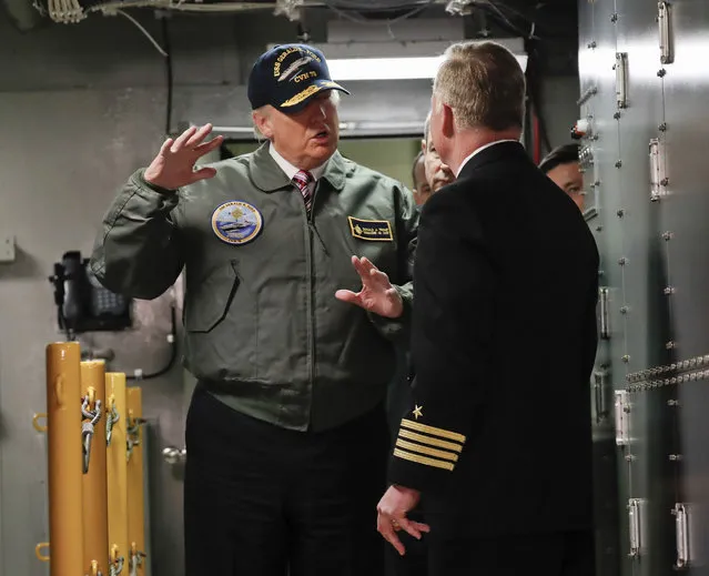 President Donald Trump talks with Capt. Richard “Rick” McCormack during a tour of the nuclear aircraft carrier Gerald R. Ford, Thursday, March 2, 2017, at Newport News Shipbuilding in Newport News, Va. Trump traveled to Virginia to meet with sailors and shipbuilders on aircraft carrier which is scheduled to be commissioned this year after cost overruns and delays. (Photo by Pablo Martinez Monsivais/AP Photo)