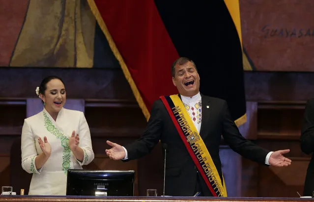 Ecuador's President Rafael Correa, right, and the President of the National Assembly Gabriela Rivadeneira sing before the ceremony to present the report on the state of the nation at National Assembly in Quito, Ecuador, Sunday, May 24, 2015. (Photo by Dolores Ochoa/AP Photo)