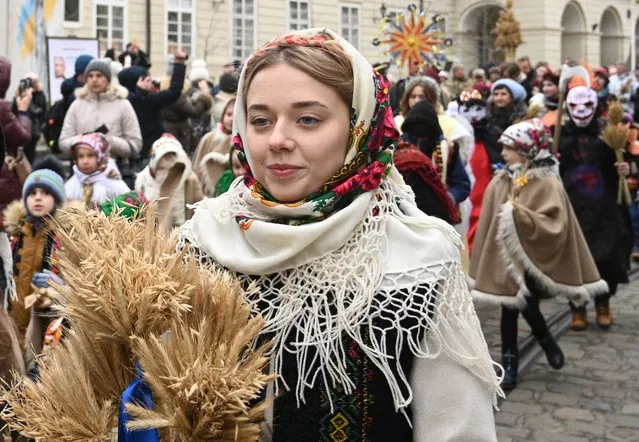 Women and children in traditional attire take part in Orthodox Christmas Eve celebrations in the western Ukrainian city of Lviv on January 6, 2023, amid the Russian invasion of Ukraine. (Photo by Yuriy Dyachyshyn/AFP Photo)