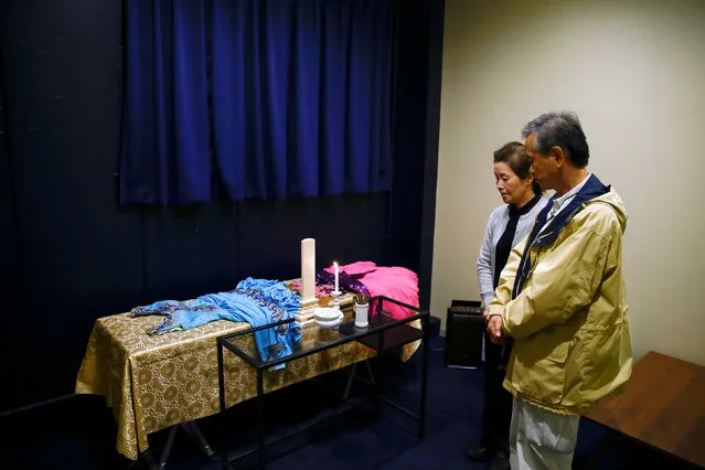 Customers Hirokazu Hosaka (R) and his wife Minako Hosaka look at the coffin of his mother at the “Corpse Hotel” in Kawasaki, Japan, April 20, 2016. (Photo by Thomas Peter/Reuters)