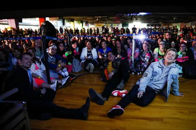 New Kids On The Block members, Jordan Knight, Jonathan Knight and Joey McIntyre watch the release of their new single with fans at an 80's style roller rink party to celebrate their new single in South Amboy, New Jersey, U.S., March 3, 2022. (Photo by Eduardo Munoz/Reuters)
