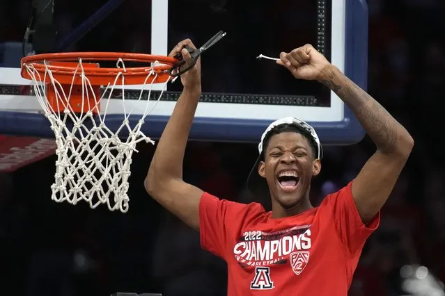 Arizona guard Dalen Terry (4) celebrates while cutting the net after an NCAA college basketball game against California, Saturday, March 5, 2022, in Tucson, Ariz. Arizona won the Pac-12 Conference Championship. (Photo by Rick Scuteri/AP Photo)