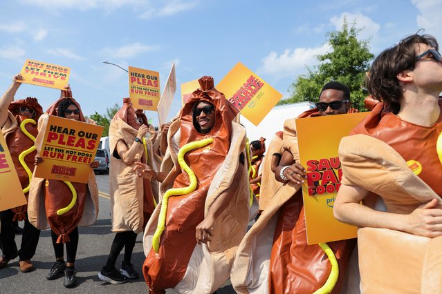 People wearing hot dog-themed costumes dance on the day of the 2024 Nathan's Famous Fourth of July International Hot Dog Eating Contest at Coney Island in New York City, U.S., July 4, 2024. (Photo by Jeenah Moon/Reuters)