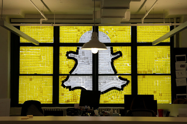 An image of the Snapchat logo created with Post-it notes is seen in the windows of Havas Worldwide at 200 Hudson Street in lower Manhattan, New York, U.S., May 18, 2016. (Photo by Mike Segar/Reuters)