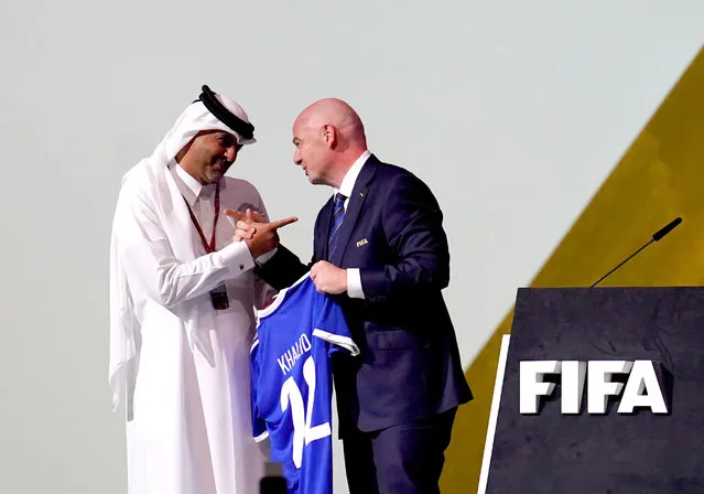 Gianni Infantino, the president of FIFA, presents Sheikh Khalid bin Khalifa bin Abdulaziz Al Thani with a shirt during the 72nd FIFA Congress at the Doha Exhibition and Convention Center, Doha on Thursday, March 31, 2022. (Photo by Nick Potts/PA Wire)