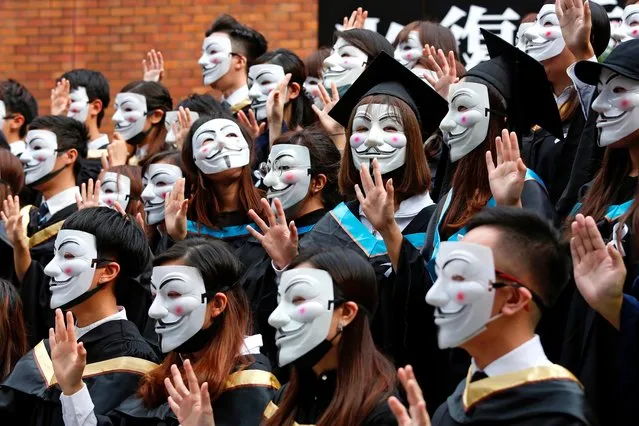 University students wearing Guy Fawkes masks pose for a photoshoot of a graduation ceremony to support anti-government protests at the Hong Kong Polytechnic University, in Hong Kong, China on October 30, 2019. (Photo by Tyrone Siu/Reuters)