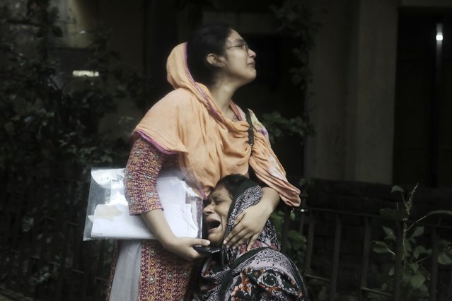 Sanjida, left, consoles her mother as she breaks into tears after receiving the dead body of her son, who was shot during a clash between the police and anti-quota protesters, at a morgue in Dhaka, Bangladesh, Monday, July 22, 2024. Internet and mobile data services are still down despite apparent calm in Bangladesh following a verdict that scaled back a controversial quota system for government jobs after weeks of relentless protests that turned deadly. (Photo by Anik Rahman/AP Photo)