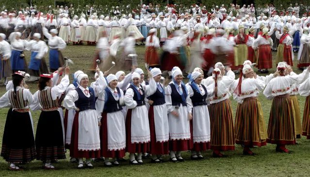 Dancers wear traditional dresses as they perform during women's dance festival in Jogeva, Estonia, June 12, 2016. (Photo by Ints Kalnins/Reuters)