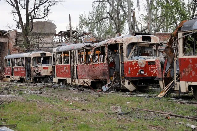 Destroyed trams stand in a depot in Mariupol, in territory under the government of the Donetsk People's Republic, eastern Ukraine, Saturday, May 21, 2022. (Photo by Alexei Alexandrov/AP Photo)