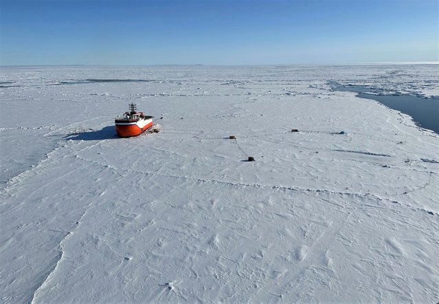 Russian scientific vessel Severny Polyus is seen caught in the arctic ice some 440km south of the north pole on June 6, 2023. A Russian national onboard the ship was evacuated at the request of their Russian counterparts. The Norwegian authorities launched a Super Puma helicopter from Longyearbyen, the main town of Svalbard, 500 nautical miles (925 km) away, to evacuate the Russian, whose state of health has was deemed too critical to be treated on board ship. “It's at the extreme limit of what the helicopter can do” in terms of range, spokesman for the Norwegian Rescue Center in Bodo, Rune Danielsen, told AFP. (Photo by Sysselmesteren Svalbard/AFP Photo)