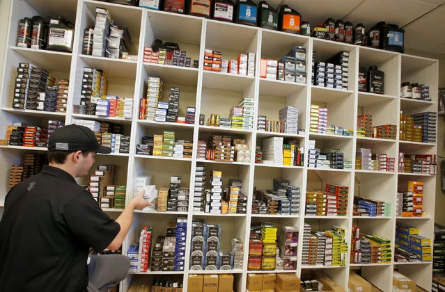 Salesman, Ryan Martinez stocks a wall of ammunition at the “Ready Gunner” gun store in Provo, Utah, U.S., June 21, 2016. (Photo by George Frey/Reuters)