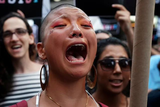 A participant cries during a protest against U.S. President Donald Trump's announcement that he plans to reinstate a ban on transgender individuals from serving in any capacity in the U.S. military, in Times Square, in New York City, New York, U.S., July 26, 2017. (Photo by Carlo Allegri/Reuters)